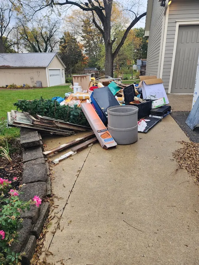 Dumpster being loaded with debris for 12 Yard Dumpster Rental in Rosenberg